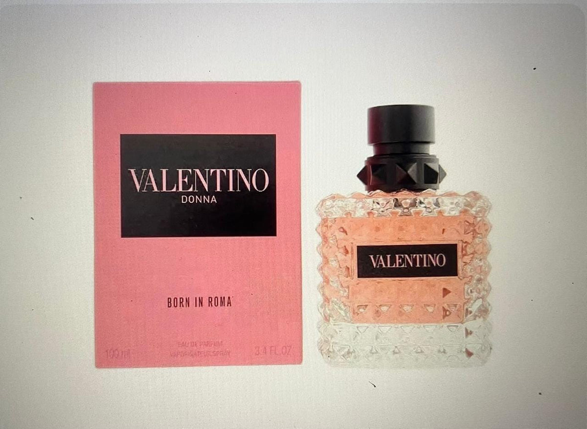 Valentino Donna Born in Roma perfume bottle next to its pink packaging box, displayed on a light gray background.