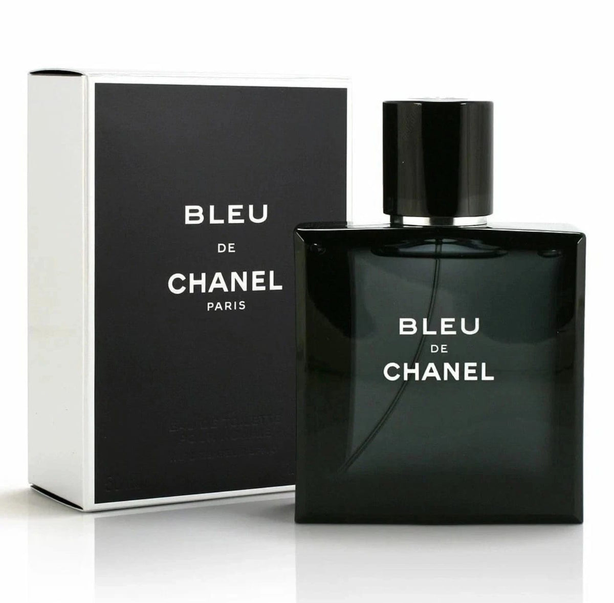 Chanel Bleu de Chanel Eau de Toilette bottle in dark green glass next to its black and white packaging box, on a white background.