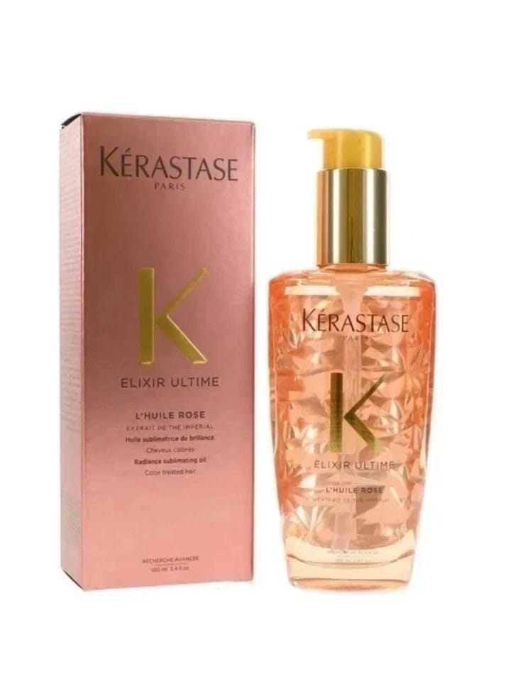 Kérastase Elixir Ultime hair oil in Rose Elixir scent, showing the clear bottle filled with peach-colored oil and a gold pump, next to its pink packaging box.