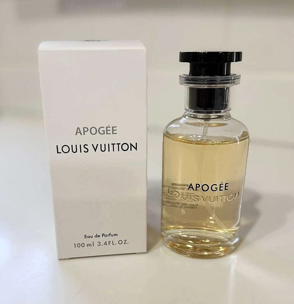 Louis Vuitton Apogée Eau de Parfum bottle with its white packaging box, displayed on a light-colored surface.
