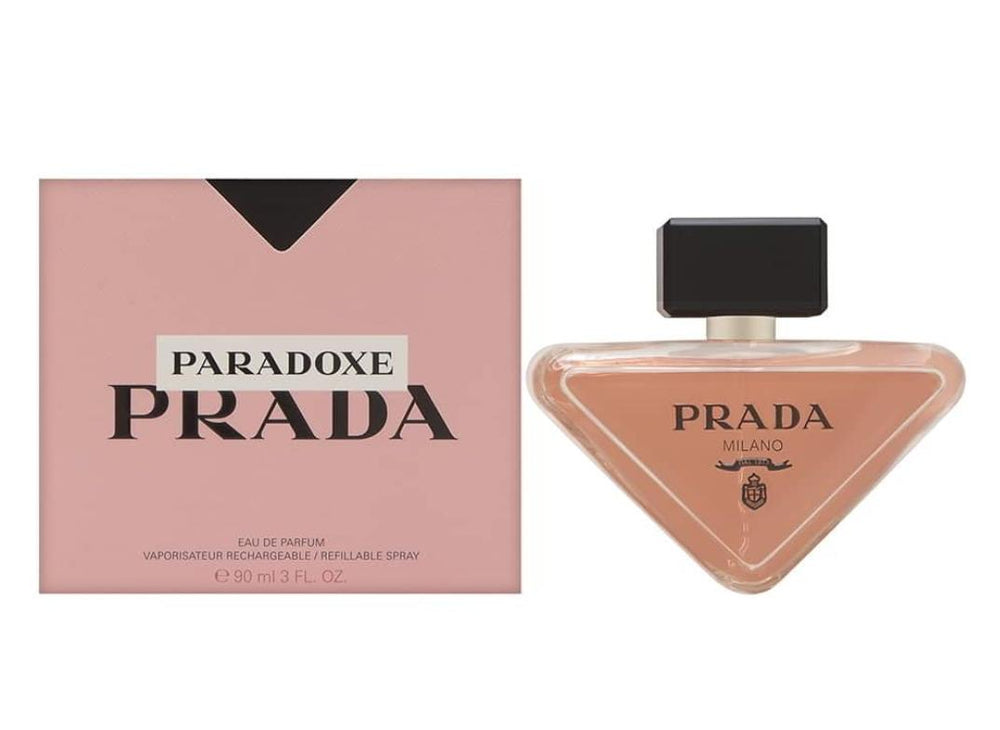 Prada Paradoxe Milano perfume bottle and its pink packaging box on a white background.